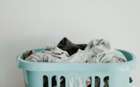 white textile on blue plastic laundry basket